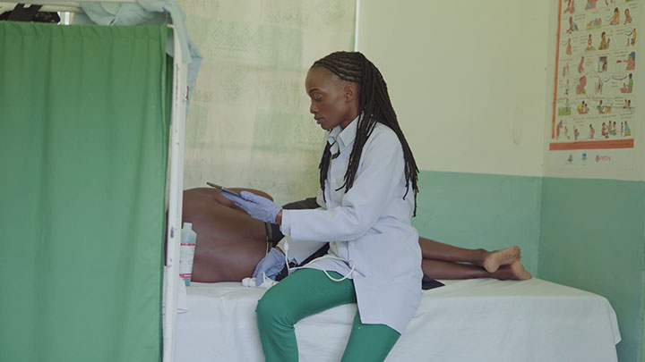 Local healthcare worker performs an ultrasound scan on a patient